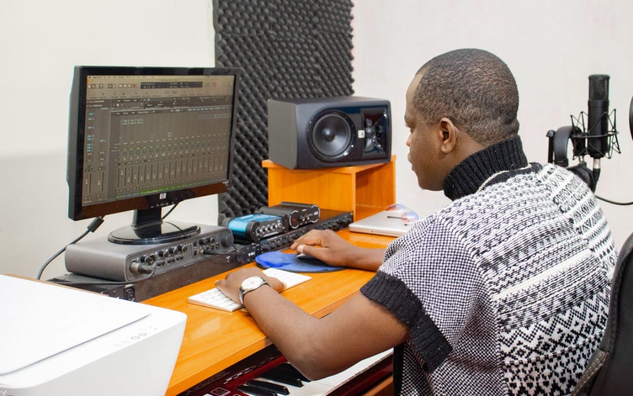 Emery Uwimana producing in the studio